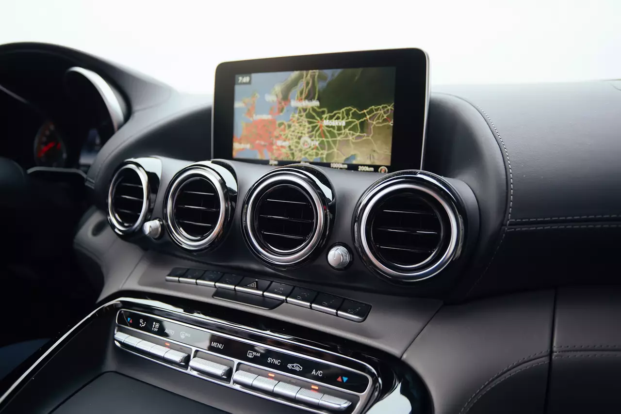 View from inside a car on a part of dashboard with a navigation unit