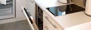 White modern kitchen with all appliance doors open
