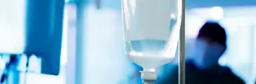 Medical fluid bag hanging with medical professionals