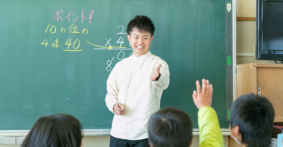 smiling teacher working with students